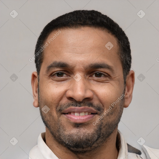 Joyful latino adult male with short  black hair and brown eyes