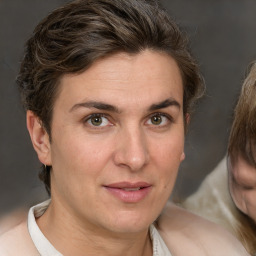 Joyful white adult female with medium  brown hair and grey eyes