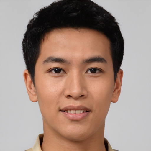 Joyful asian young-adult male with short  black hair and brown eyes