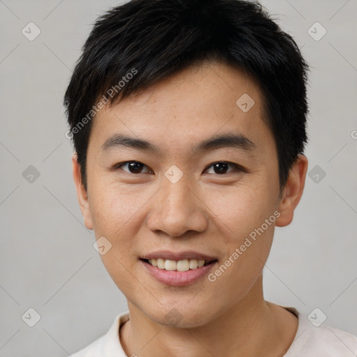 Joyful asian young-adult male with short  black hair and brown eyes