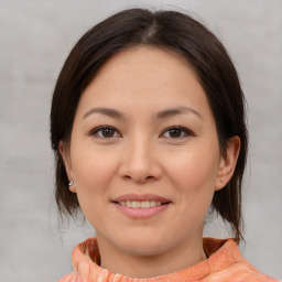 Joyful asian young-adult female with medium  brown hair and brown eyes