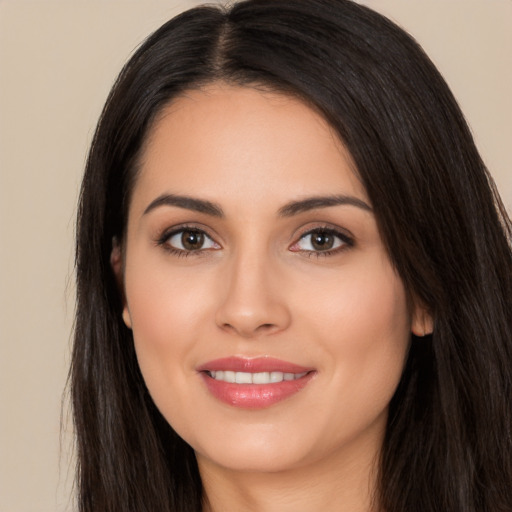 Joyful white young-adult female with long  black hair and brown eyes