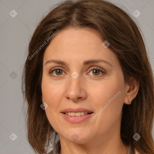 Joyful white adult female with long  brown hair and brown eyes