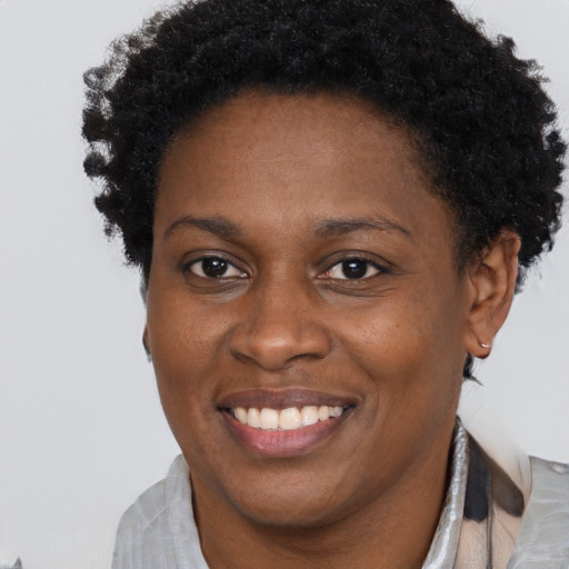 Joyful black adult female with short  brown hair and brown eyes