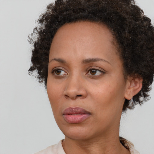 Neutral black adult female with short  brown hair and brown eyes