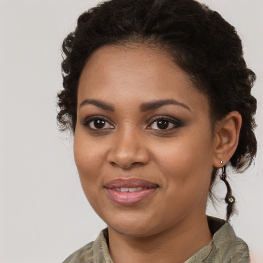 Joyful black young-adult female with medium  brown hair and brown eyes