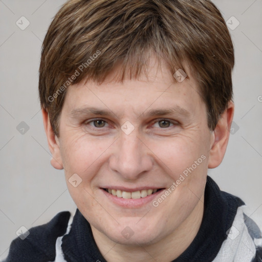 Joyful white adult male with short  brown hair and grey eyes