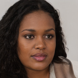 Joyful black young-adult female with long  brown hair and brown eyes