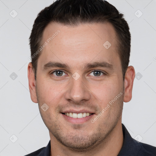 Joyful white young-adult male with short  brown hair and grey eyes