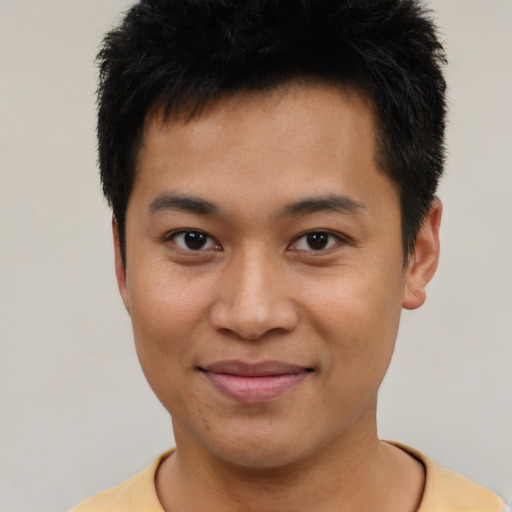 Joyful asian young-adult male with short  brown hair and brown eyes