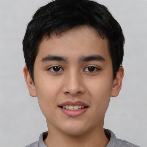 Joyful asian young-adult male with short  black hair and brown eyes