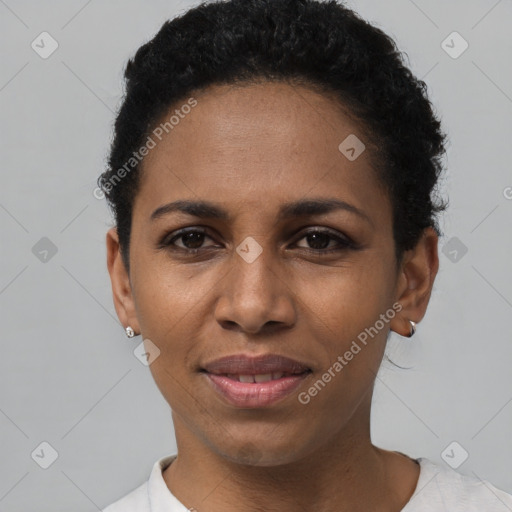 Joyful black young-adult female with short  black hair and brown eyes