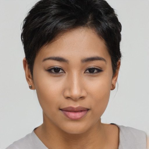 Joyful latino young-adult female with short  brown hair and brown eyes