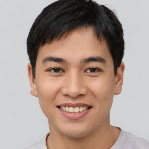 Joyful asian young-adult male with short  brown hair and brown eyes