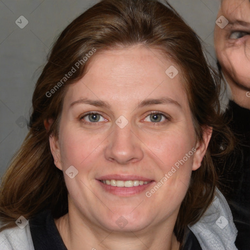 Joyful white adult female with medium  brown hair and blue eyes