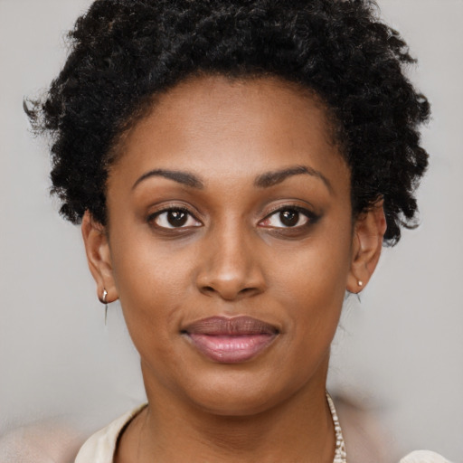 Joyful black young-adult female with short  brown hair and brown eyes