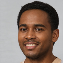 Joyful black young-adult male with short  black hair and brown eyes