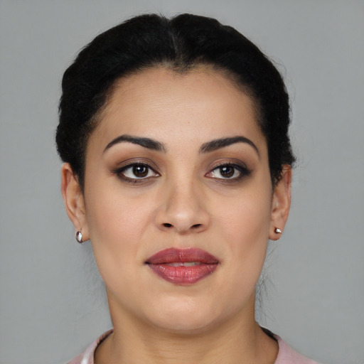 Joyful latino young-adult female with short  brown hair and brown eyes