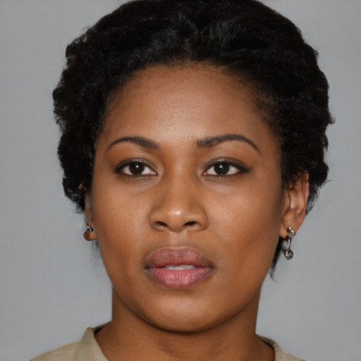 Joyful black young-adult female with short  black hair and brown eyes