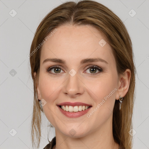 Joyful white young-adult female with long  brown hair and green eyes