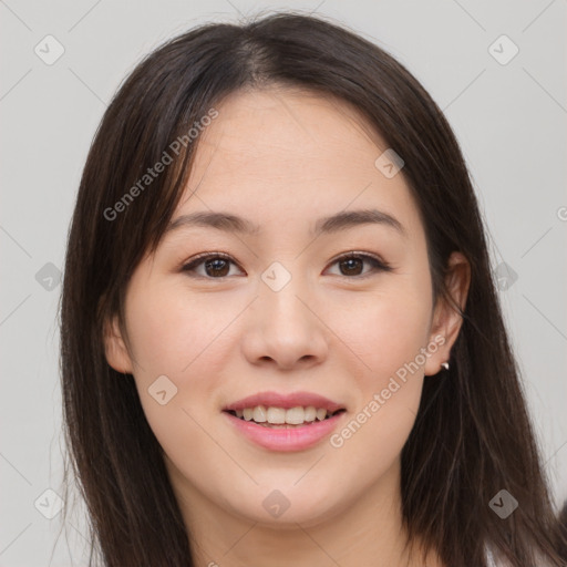 Joyful asian young-adult female with long  brown hair and brown eyes