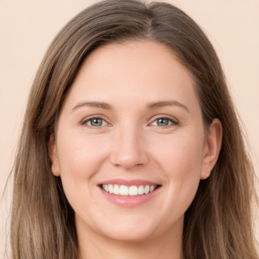 Joyful white young-adult female with long  brown hair and grey eyes