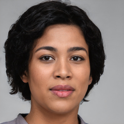 Joyful latino young-adult female with medium  black hair and brown eyes
