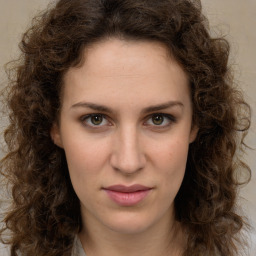 Joyful white young-adult female with long  brown hair and green eyes