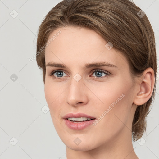 Joyful white young-adult female with medium  brown hair and grey eyes