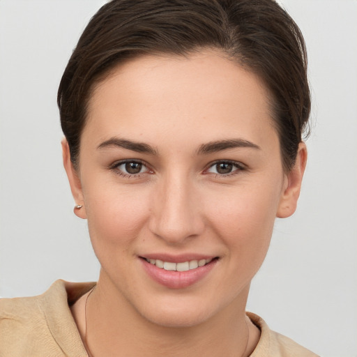 Joyful white young-adult female with short  brown hair and brown eyes