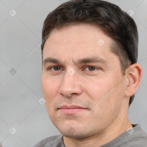 Joyful white adult male with short  brown hair and brown eyes