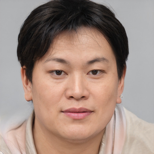 Joyful asian young-adult female with short  brown hair and brown eyes
