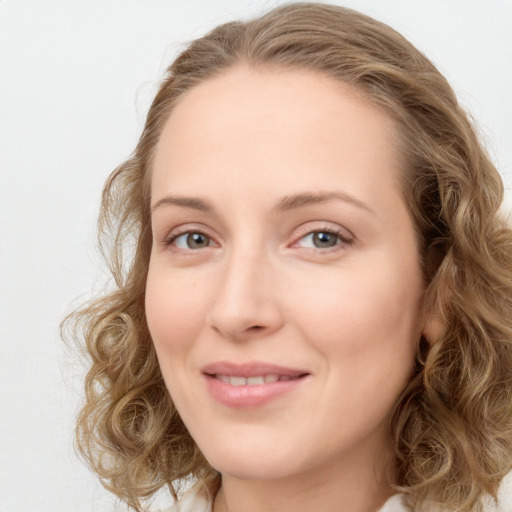 Joyful white young-adult female with long  brown hair and green eyes