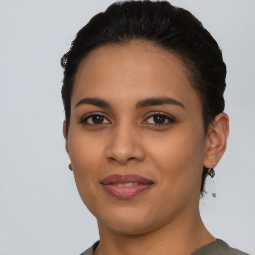Joyful latino young-adult female with short  black hair and brown eyes