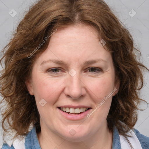 Joyful white adult female with medium  brown hair and blue eyes