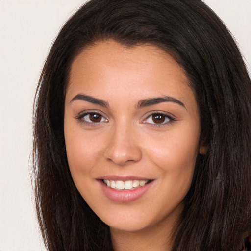 Joyful white young-adult female with long  brown hair and brown eyes