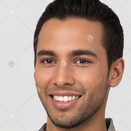 Joyful white young-adult male with short  brown hair and brown eyes