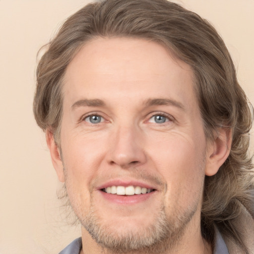 Joyful white adult male with short  brown hair and grey eyes