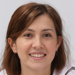 Joyful white young-adult female with medium  brown hair and brown eyes