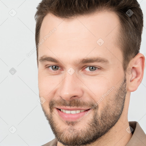 Joyful white young-adult male with short  brown hair and brown eyes