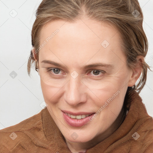 Joyful white young-adult female with medium  brown hair and blue eyes