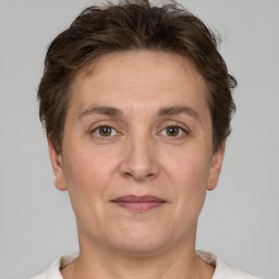 Joyful white adult female with short  brown hair and brown eyes