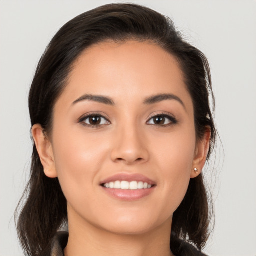 Joyful white young-adult female with long  brown hair and brown eyes