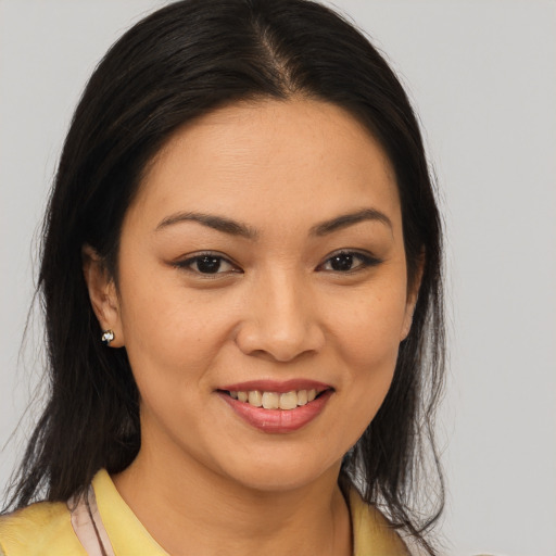 Joyful asian young-adult female with long  brown hair and brown eyes