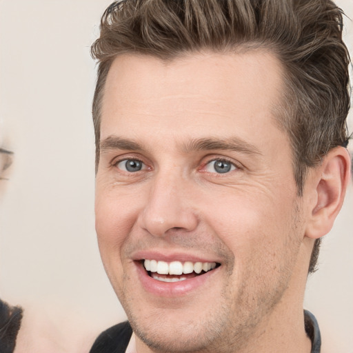 Joyful white adult male with short  brown hair and grey eyes