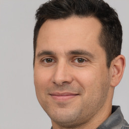 Joyful white adult male with short  brown hair and brown eyes