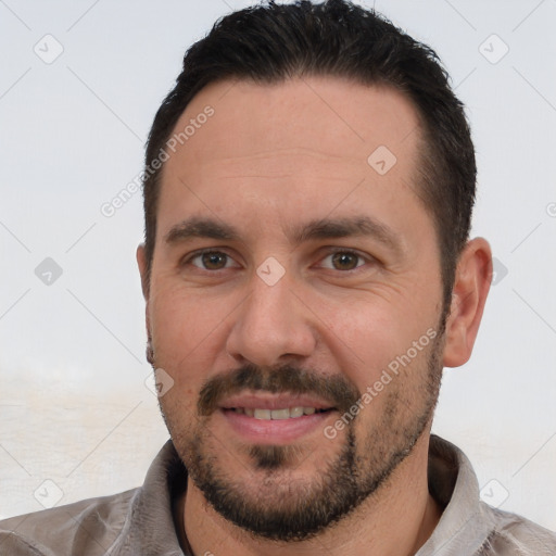 Joyful white adult male with short  black hair and brown eyes