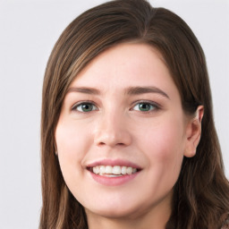 Joyful white young-adult female with long  brown hair and green eyes