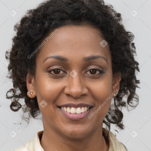 Joyful black young-adult female with long  brown hair and brown eyes