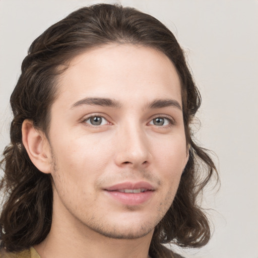 Joyful white young-adult male with medium  brown hair and brown eyes